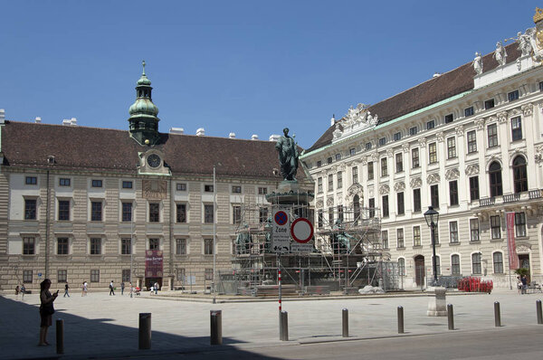 Vienna, Austria - 04 July 2015 : Internal court of Hofburg Imperial Palace - one of the main tourist attractions of Vienna . On the backplane: monument of the Archduke Franz II under reconstruction.