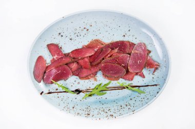 Beyaz arka plan üzerinde izole yeşil roka ile devekuşu basturma taze barışlar