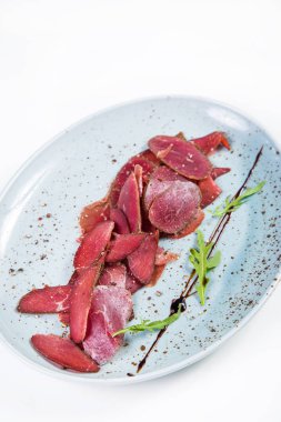 Beyaz arka plan üzerinde izole yeşil roka ile devekuşu basturma taze barışlar