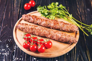 domates ve maydanoz siyah ahşap zemin üzerine sıcak kızarmış kebabı