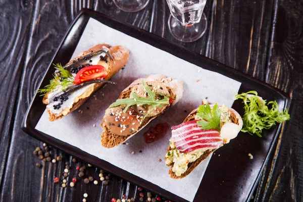 Bruschetta Con Arenque Paté Carne Sobre Fondo Madera Negro — Foto de Stock