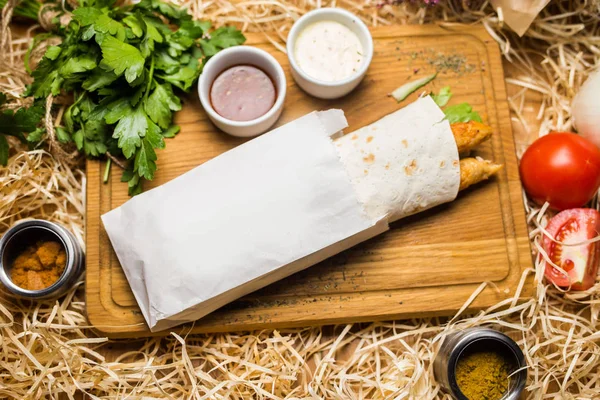 Shawerma on wooden plate in studio — Stock Photo, Image