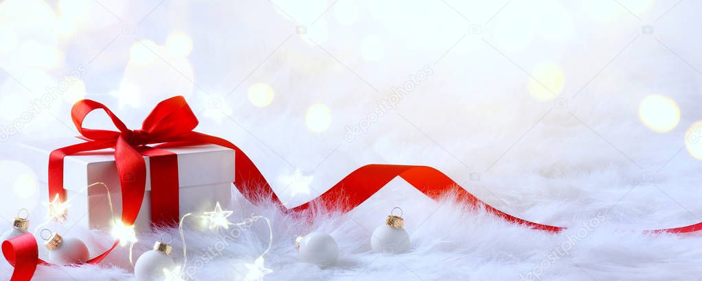 Christmas background with holidays gift box and Christmas decoration on red backgroun