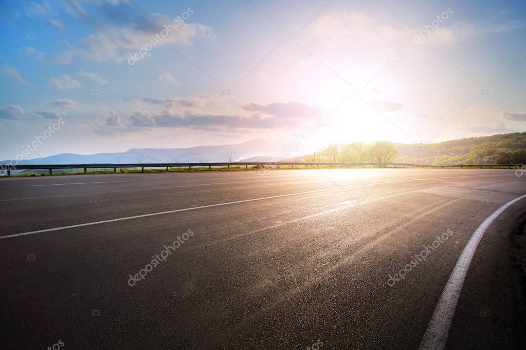 empty asphalt highway road bend and sunset sk