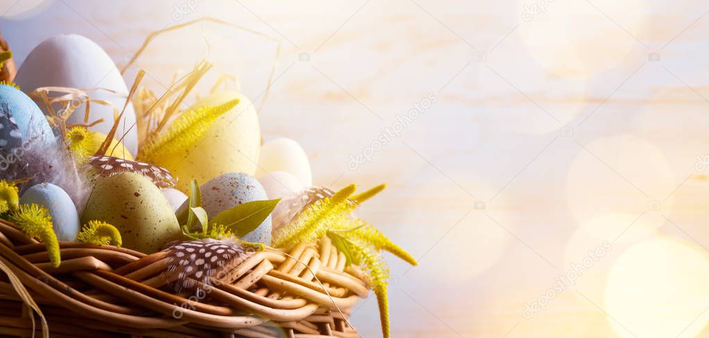 sunny Easter background with Easter eggs in the basket