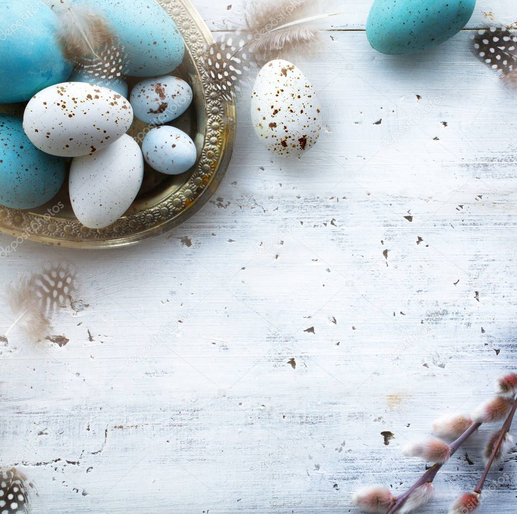 Sunny Easter background with Easter eggs on white tabl