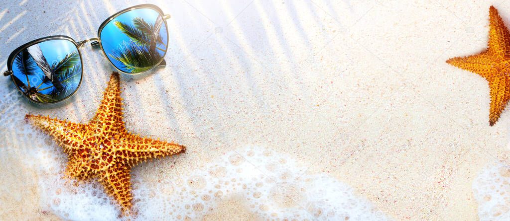 Art Summer Beach background with sunglass and starfish on sand; Tropical sea vacation concep
