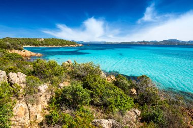The beautiful turquoise and crystal clear sea on the beach of Petra Ruja - Olbia / Tempio - Sardinia - Italy clipart