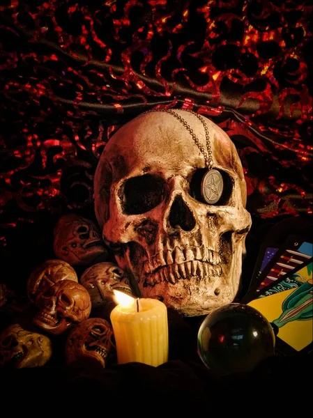 Skull, candle, crystal ball, and other occult paraphernalia, a creepy still life. All artwork by Darla Hallmark.