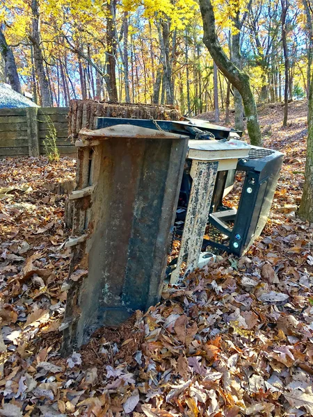 A small bob cat, tractor, fallen on the side during a job of building a drainage system.