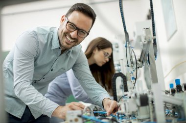 Robotik laboratuarda çalışan öğrencilerin genç çift