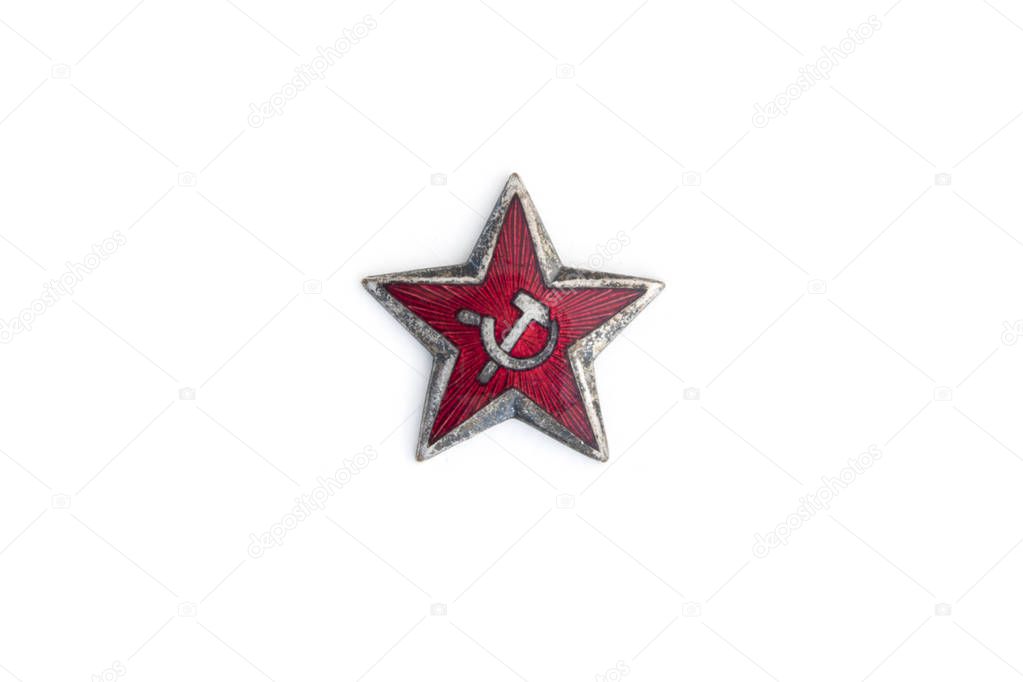 Old red star from communist military cap isolated on the white background