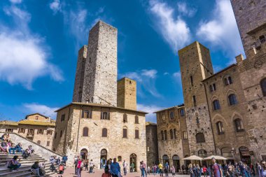 San Gimignano, İtalya - 8 Nisan 2018: San Gimignano, İtalya için Piazza del Duomo kimliği belirsiz kişi. San Gimignano tarihi merkezi 1990 yılından bu yana Unesco Dünya Mirası alanı belirlenmiş.