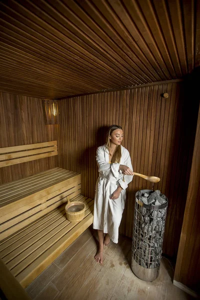 Pretty young woman relaxing in the sauna