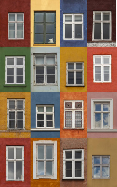Windows on the colorful facades from Nyhavn harbour, Copenhagen, Denmark