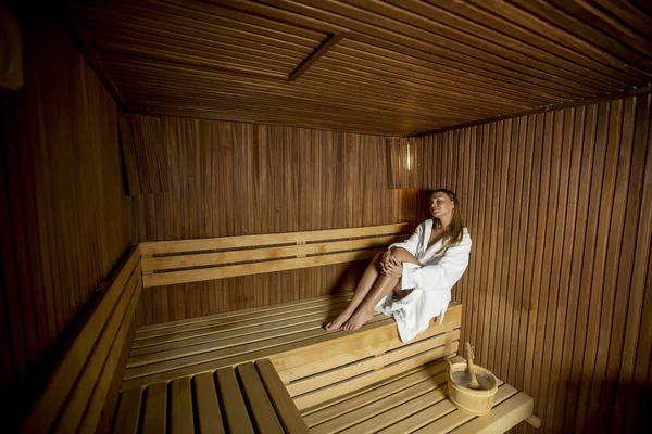 Pretty young woman relaxing in the sauna