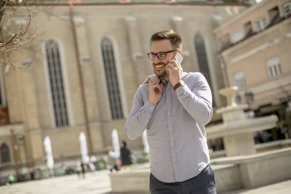 Cheerful Young Man Uses Mobile Phone Urban Enviroment Sunny Day — Stock Photo, Image