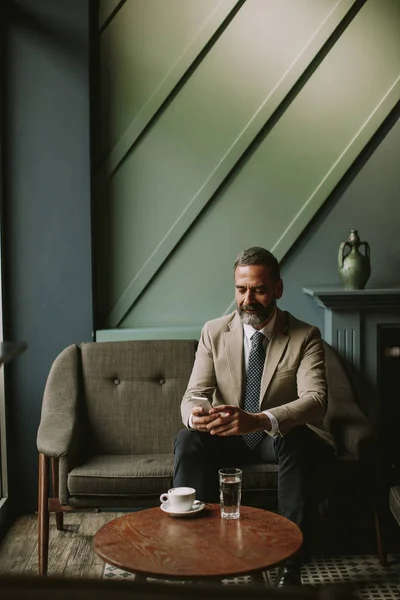 Portrait Handsome Senior Businessman Drinking Coffee Using Mobile Phone Lobby — Stock Photo, Image