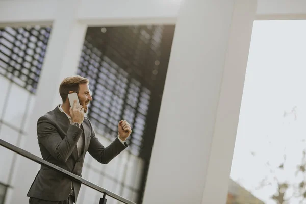 Young Successful Businessman Wearing Grey Suit Holding His Smartphone While — Stock Photo, Image
