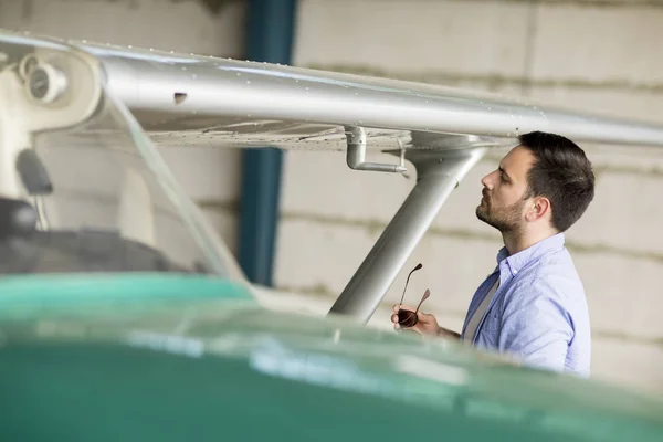 Handsome Young Pilot Checking Airplane Hangar — Stock Photo, Image