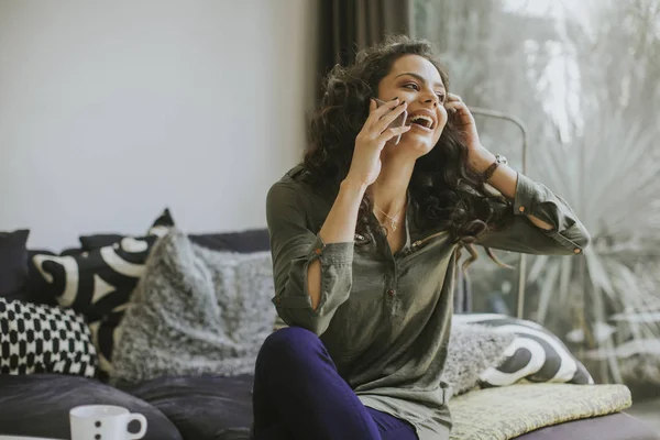 Curly Hair Young Woman Using Mobile Phone Holding Mug While — Stock Photo, Image