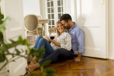 Sevgi dolu çift birbirine evde kırmızı şarap içme bakarak