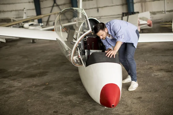 Handsome Young Pilot Checking Airplane Hangar — Stock Photo, Image