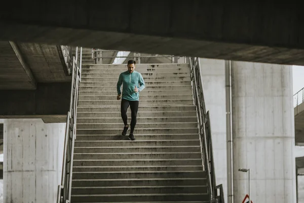 Young man running fast down the stairs in the city