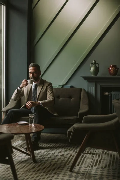 Portrait Handsome Senior Businessman Drinking Coffee Using Mobile Phone Lobby — Stock Photo, Image