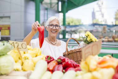 İyi görünümlü kadın kıdemli gözlük portresi biber piyasada satın alır.