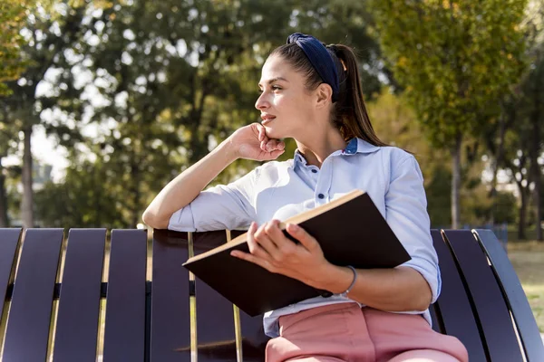 Cheerfull Young Woman Holding Open Book Reading Bench Autumn Park — Stock Photo, Image