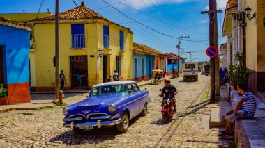 TRINIDAD, CUBA - MAY 25, 2014: Unidentified people on the street of Trinidad, Cuba. Trinidad has been a UNESCO World Heritage site since 1988. clipart