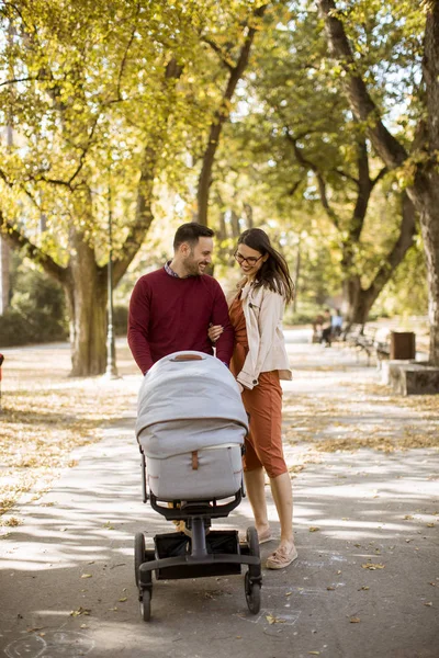 Happy Young Parents Walking Autumn Park Driving Baby Baby Carriage — Stock Photo, Image