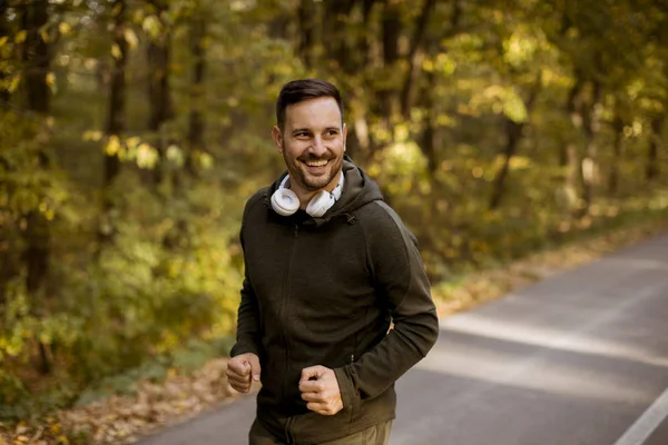 Handsome Young Man Running Autumn Forest Earphones — Stock Photo, Image