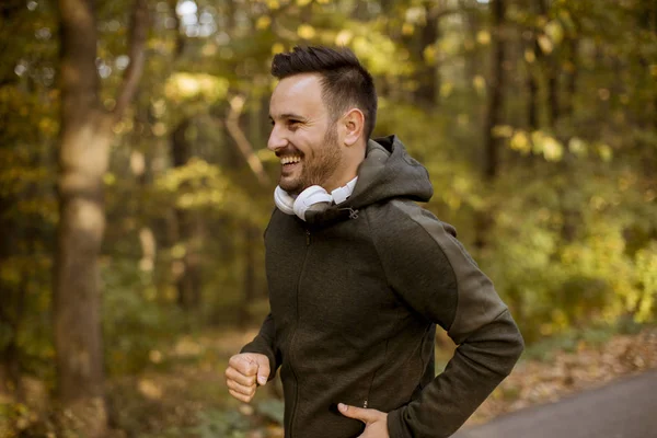 Handsome Young Man Running Autumn Forest Earphones — Stock Photo, Image
