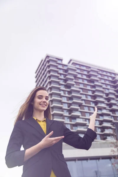 Portrait of young businesswoman outdoor against office building