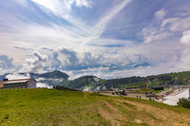 RIGI CULM, SWITZERLAND - MAY 19, 2018: Unidentified people on the Rigi Kulm in Switzerland. With 1797 meters above sea level, Rigi Kulm is the highest peak of Mount Rigi. clipart