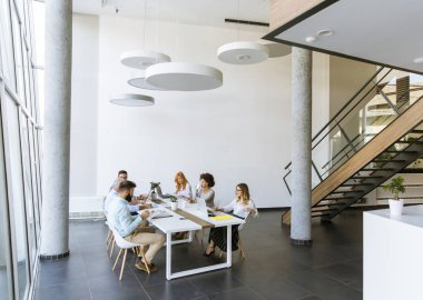 Görünümü çok ırklı iş adamları toplantı ve gülümseyen personel sırasında masa etrafında