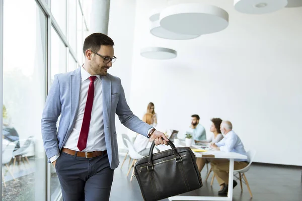 Joven Hombre Negocios Deja Una Reunión Mientras Otros Empresarios Permanecen — Foto de Stock