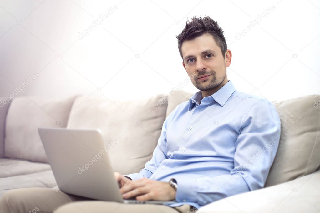 Male freelancer working on laptop  from home
