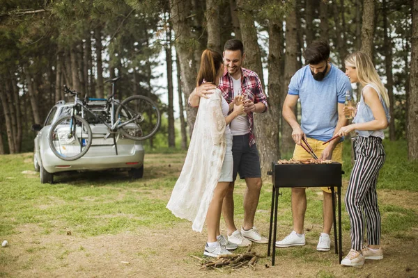 Group of young people enjoying barbecue party in the nature