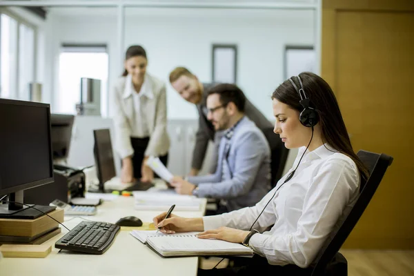 People working in a busy office as a teamwork concept