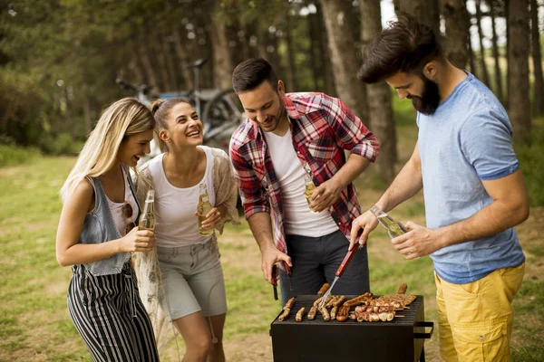 Young people enjoying barbecue party in the nature