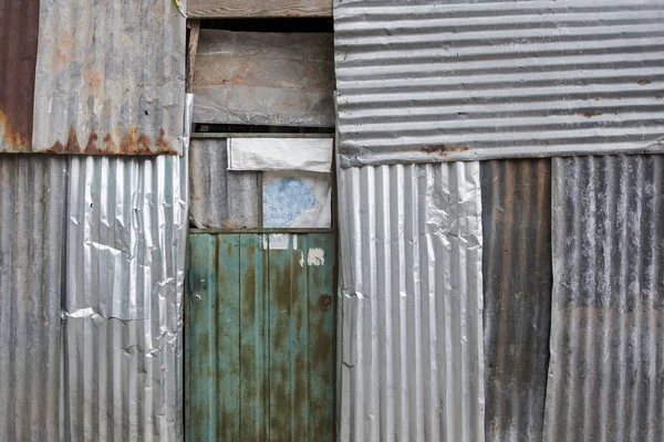 Closeup of the old metal sheet house facade