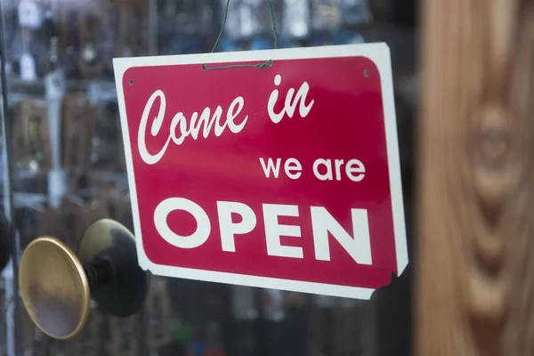 Closeup of the open sign on the glass of shop or cafe window