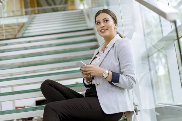 Hübsche Junge Geschäftsfrau Sitzt Auf Der Treppe Büro Und Benutzt — Stockfoto