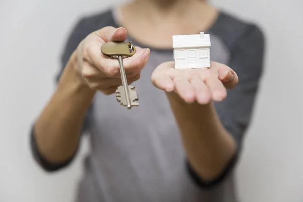 Female holding small house model and keys, real estate concept — Stock Photo, Image