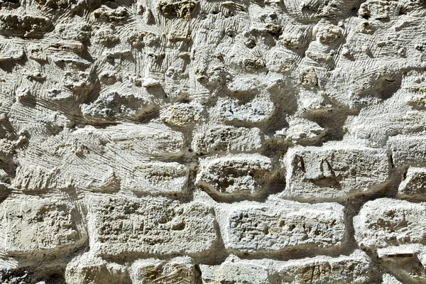 Detail of the white stone wall background texture