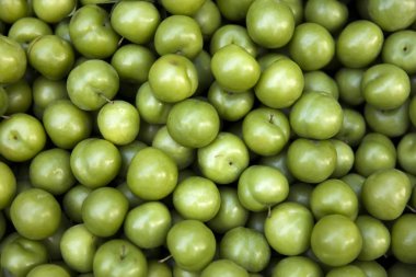 Heap of fresh organic green plums, greengage, at street market in Istanbul, Turkey clipart