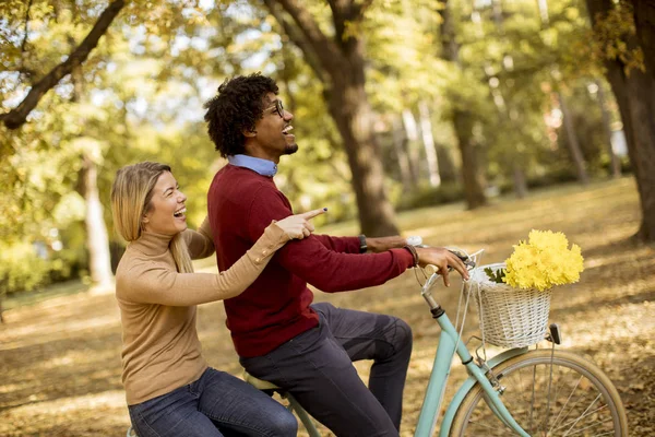 Multiracial Young Couple Riding Bicycle Autumn Park — Stock Photo, Image